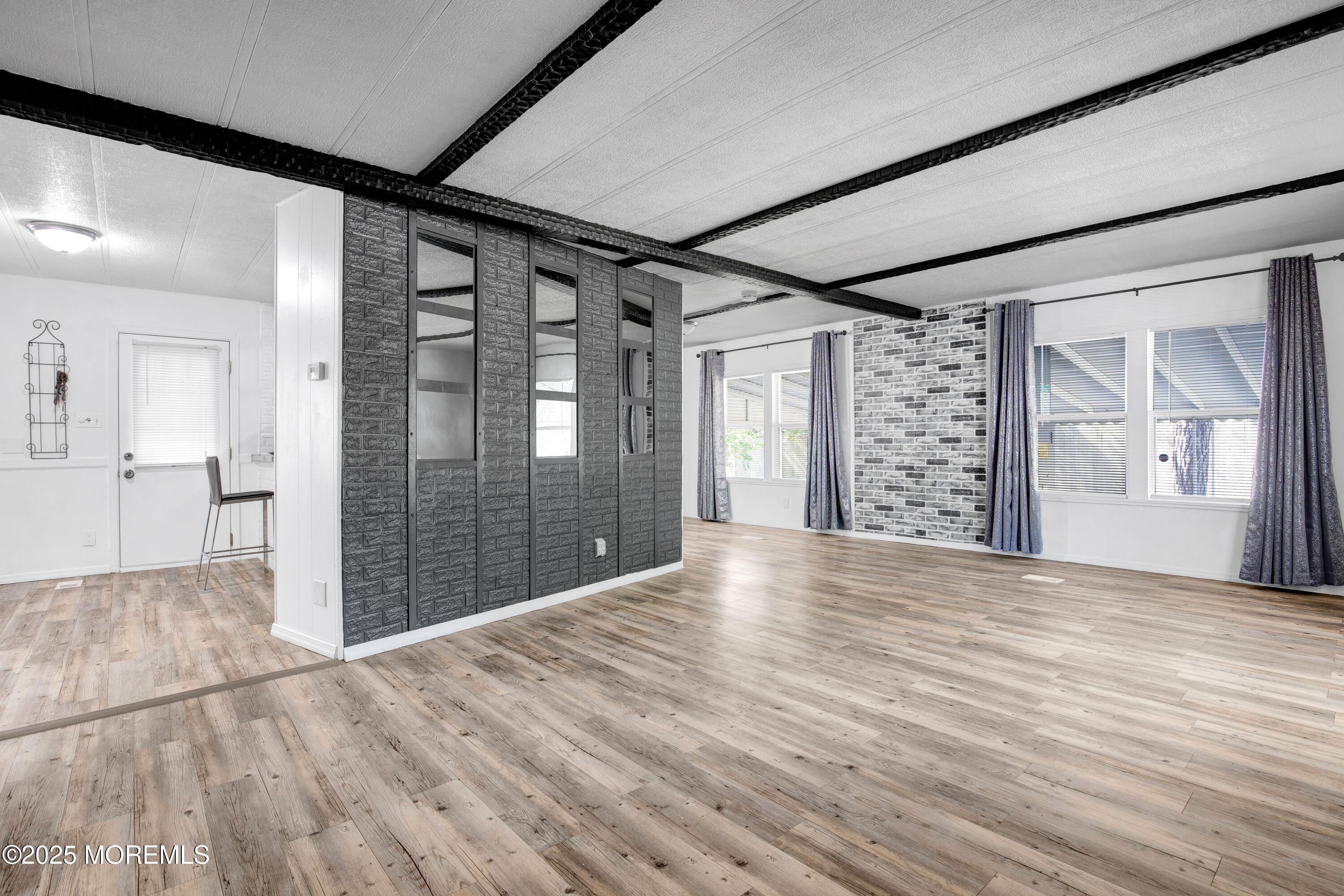 209 Mockingbird Way Whiting, NJ 08759 - Photo 5 of 26 en empty room with wooden floor and windows