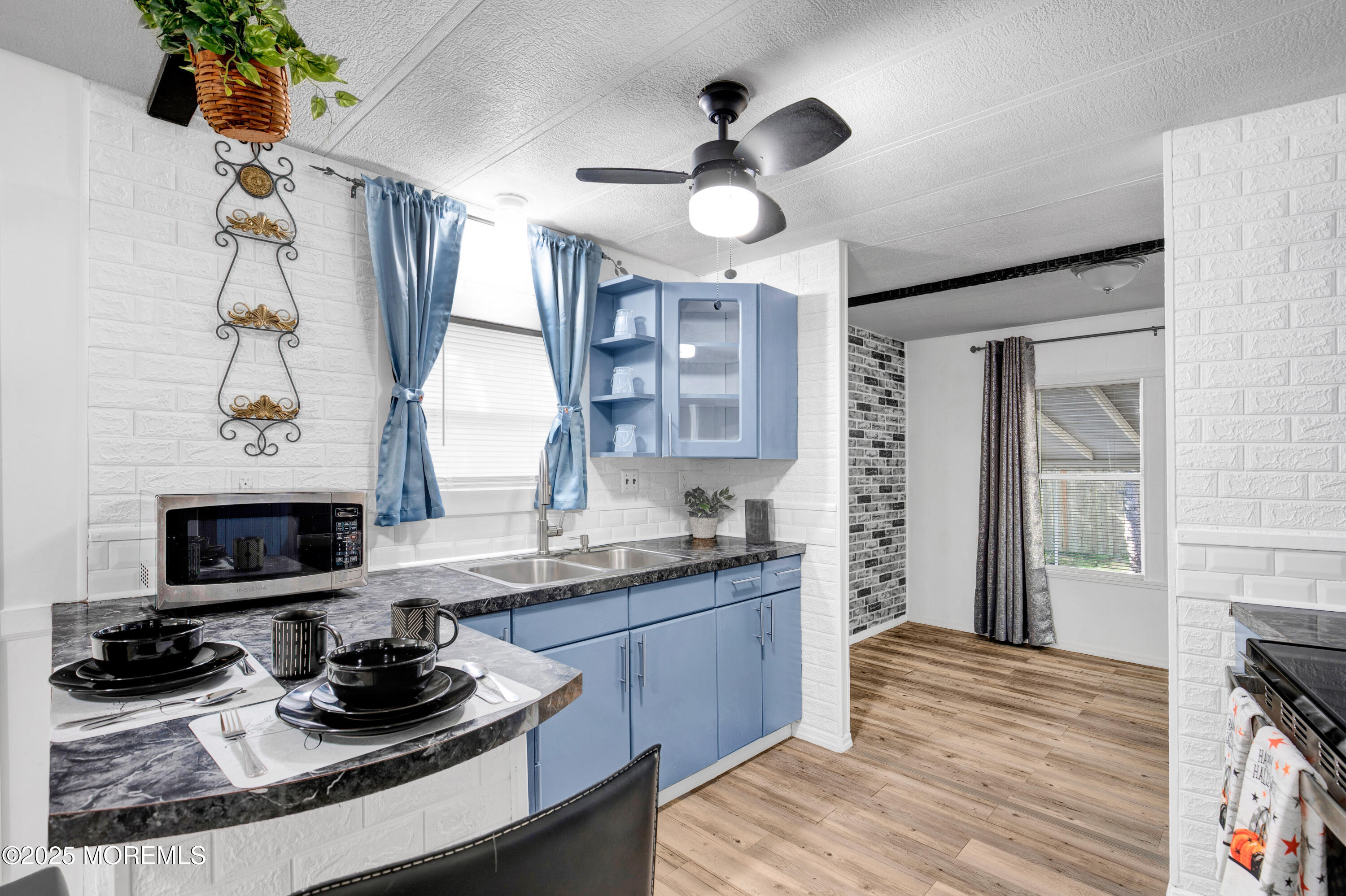 209 Mockingbird Way Whiting, NJ 08759 - Photo 10 of 26 a kitchen with stainless steel appliances a stove and a wooden floor