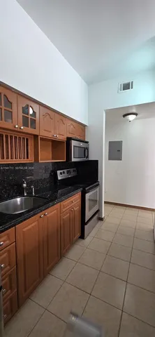 a kitchen that has a sink and cabinets