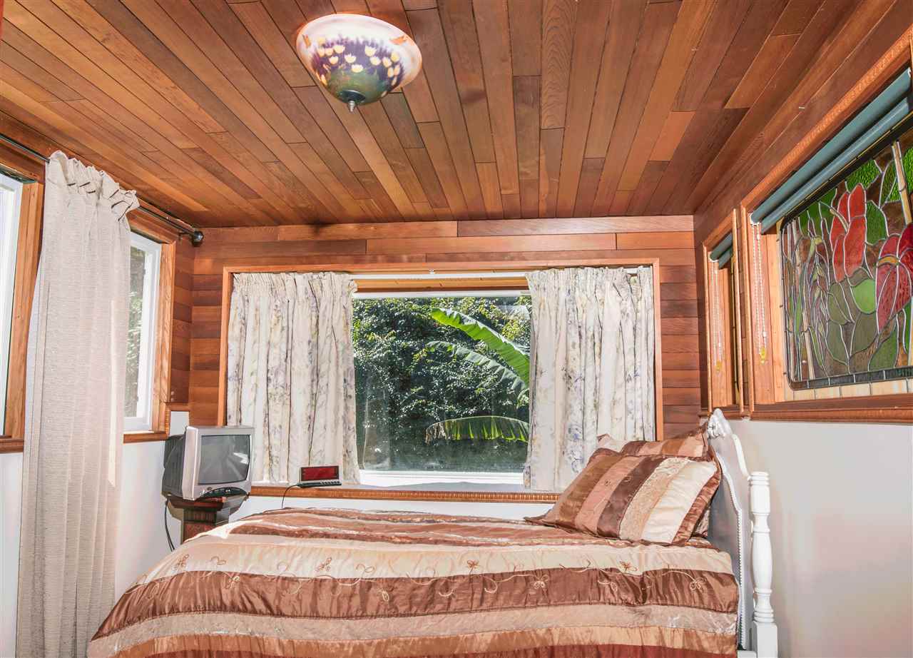 900 Haiku Road Haiku, HI 96708 - Photo 11 of 15 a bedroom with a bed and a large window