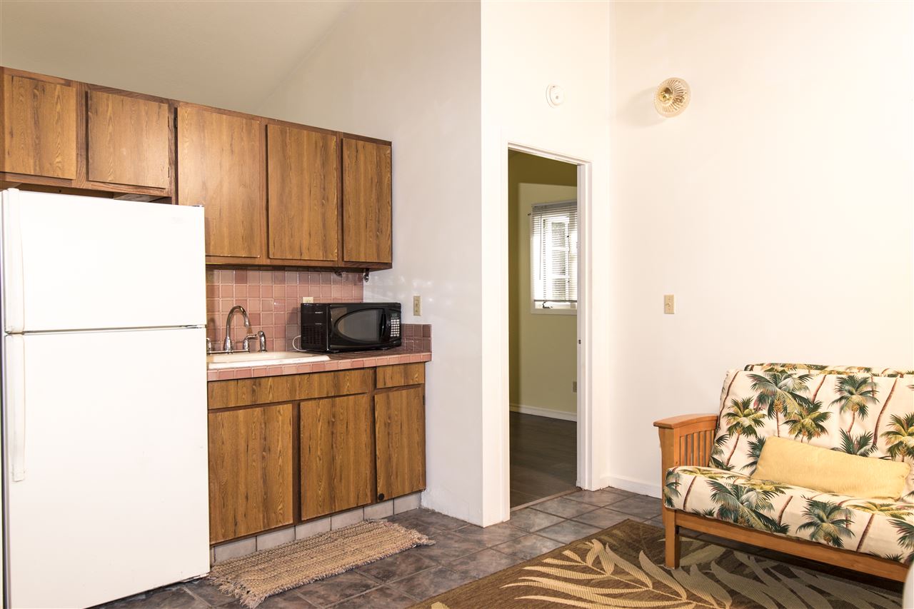 900 Haiku Road Haiku, HI 96708 - Photo 14 of 15 a kitchen with a refrigerator and a stove