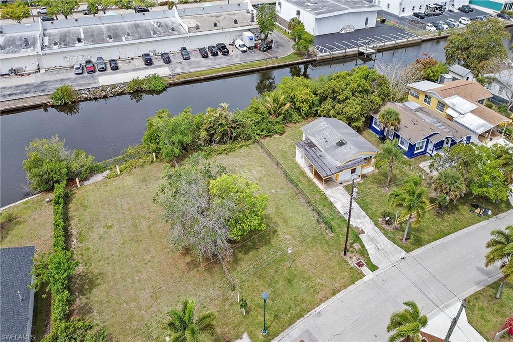 531 13th Street North Naples, FL 34102 - Photo 3 of 13 a aerial view of a house with a yard and lake view