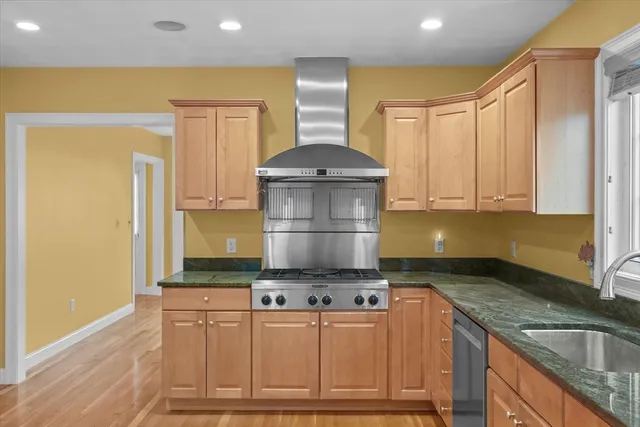 a kitchen with granite countertop a stove and a sink