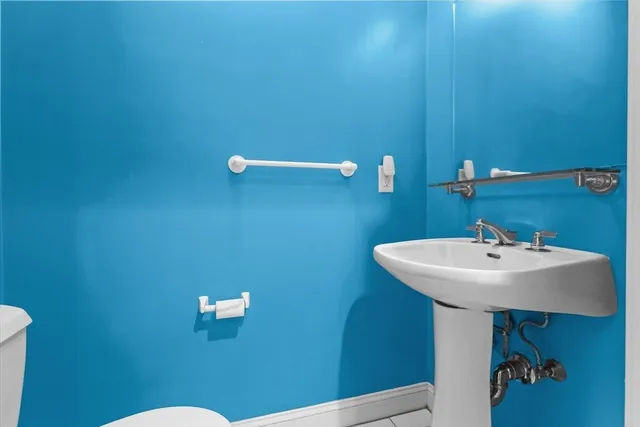 a bathroom with a sink a mirror and a toilet