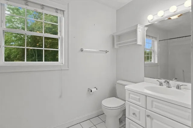 a bathroom with a toilet sink and a mirror