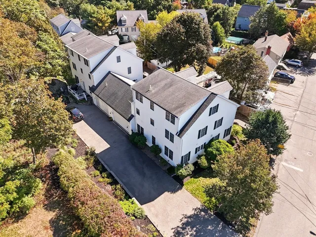 an aerial view of a house with a yard