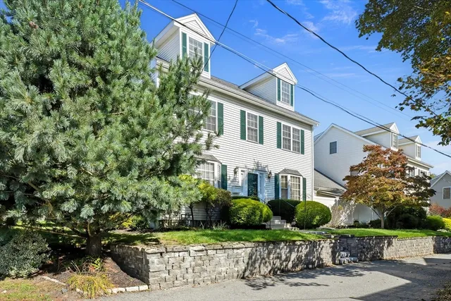 a front view of a house with a garden