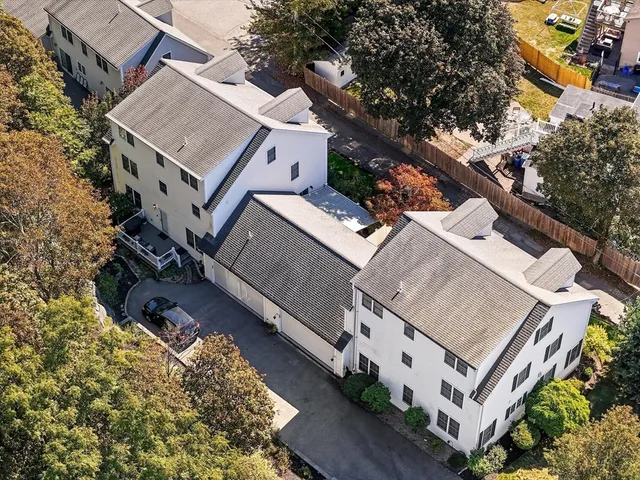 an aerial view of a house with a yard