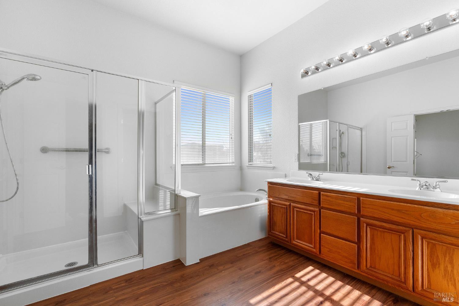 139 Cedar Ridge Drive Rio Vista, CA 94571 - Photo 25 of 52 Primary bath offers dual vanity sinks, tub plus a walk-in shower with bench seating and safety grab bar.