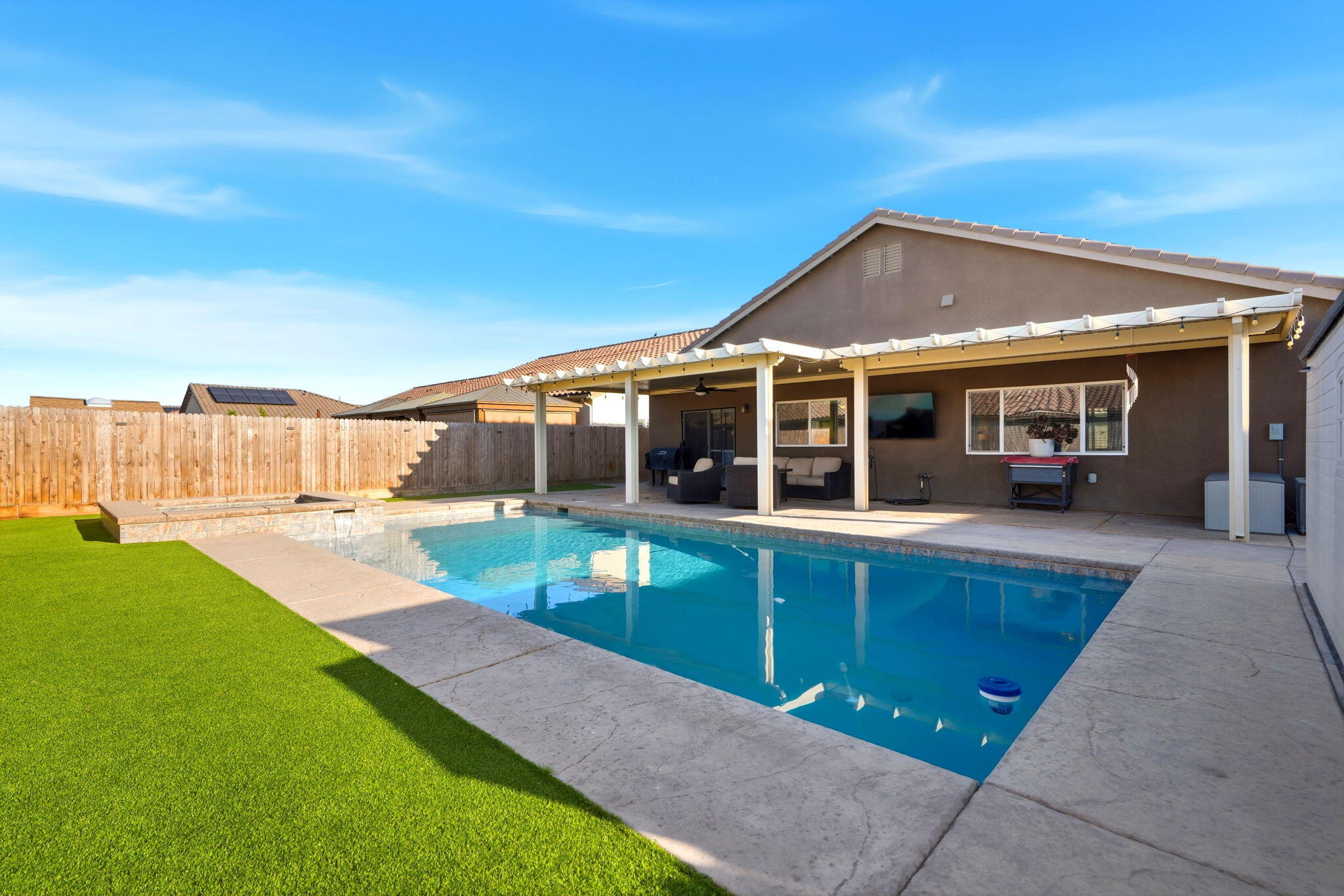 756 Strada Street Lemoore, CA 93245 - Photo 39 of 53 a view of a house with a swimming pool and a yard