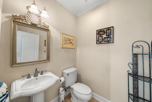 a bathroom with a toilet a sink and mirror
