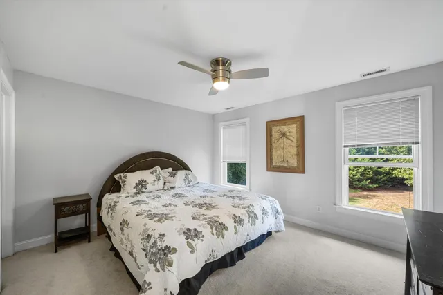 a bed sitting in a bedroom next to a window