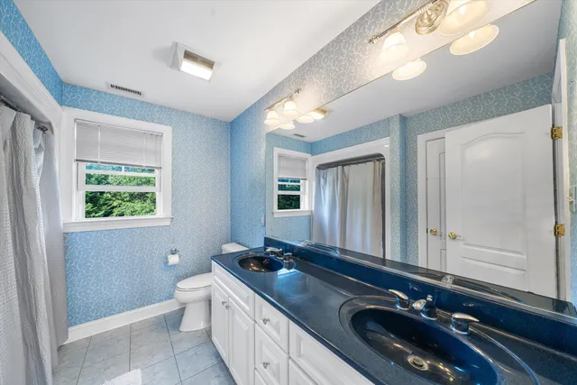 a bathroom with a double vanity sink and a mirror