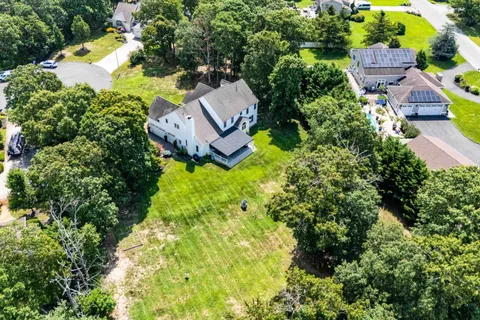 an aerial view of a house with garden space and street view