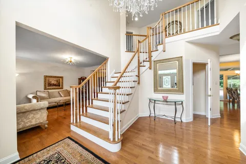 a view of entryway and hall with wooden floor