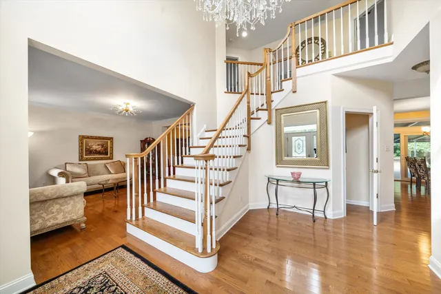 a view of entryway and hall with wooden floor
