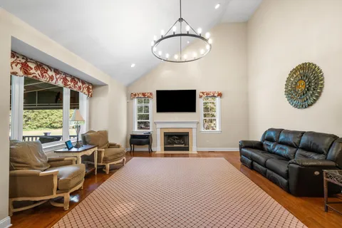 a living room with furniture a fireplace and a flat screen tv