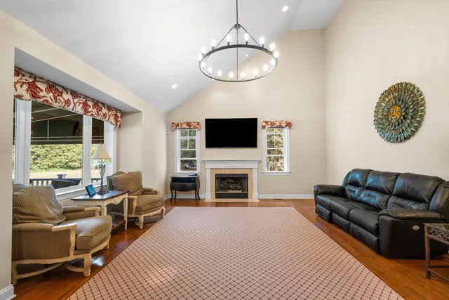 a living room with furniture a fireplace and a flat screen tv