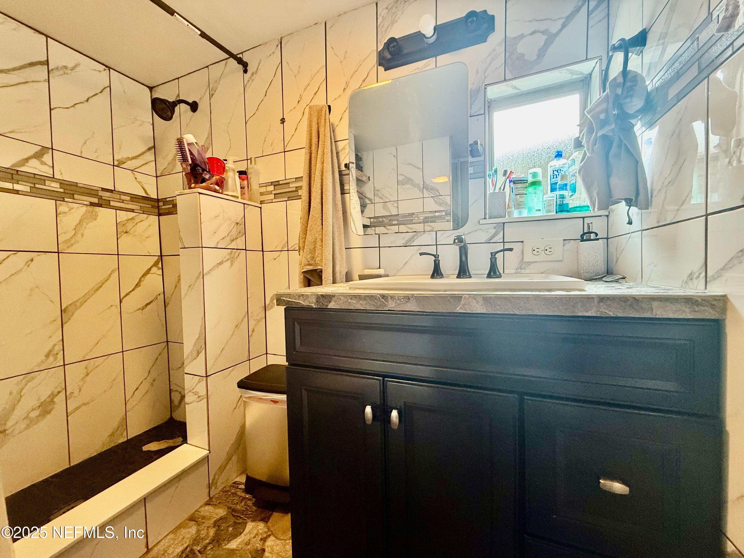 239 Pine Tree Trail Crescent City, FL 32112 - Photo 14 of 21 a bathroom with a granite countertop sink a mirror and shower