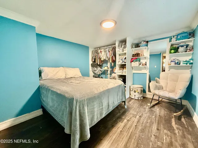 a bedroom with a bed and a dresser