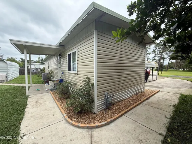 a view of a backyard with sitting area