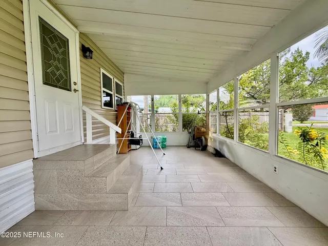a view of a room with wooden floor and stairs