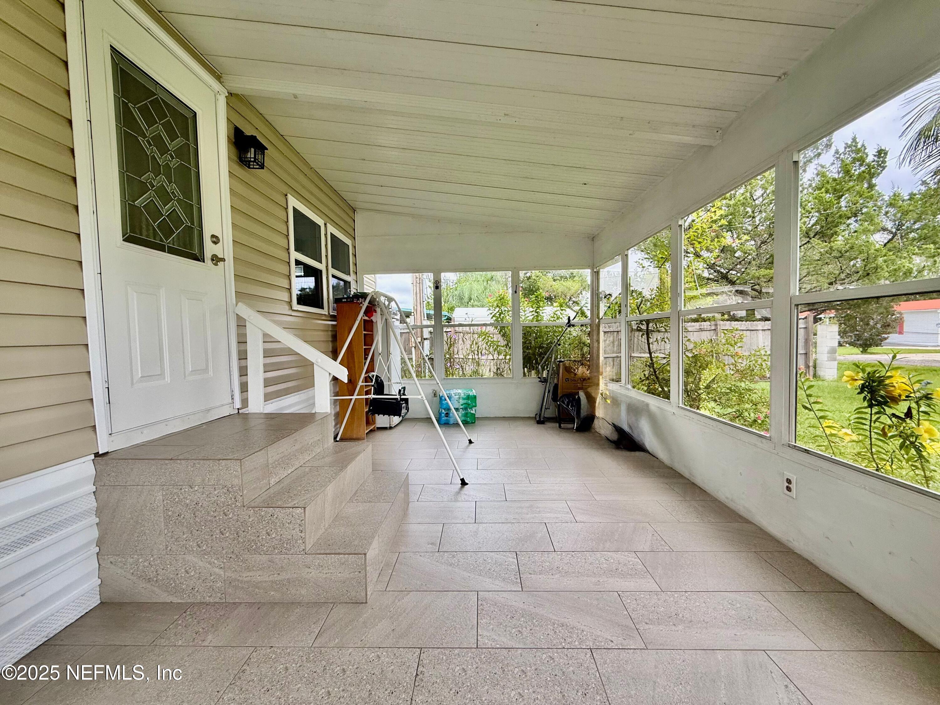 239 Pine Tree Trail Crescent City, FL 32112 - Photo 5 of 21 a view of a room with wooden floor and stairs
