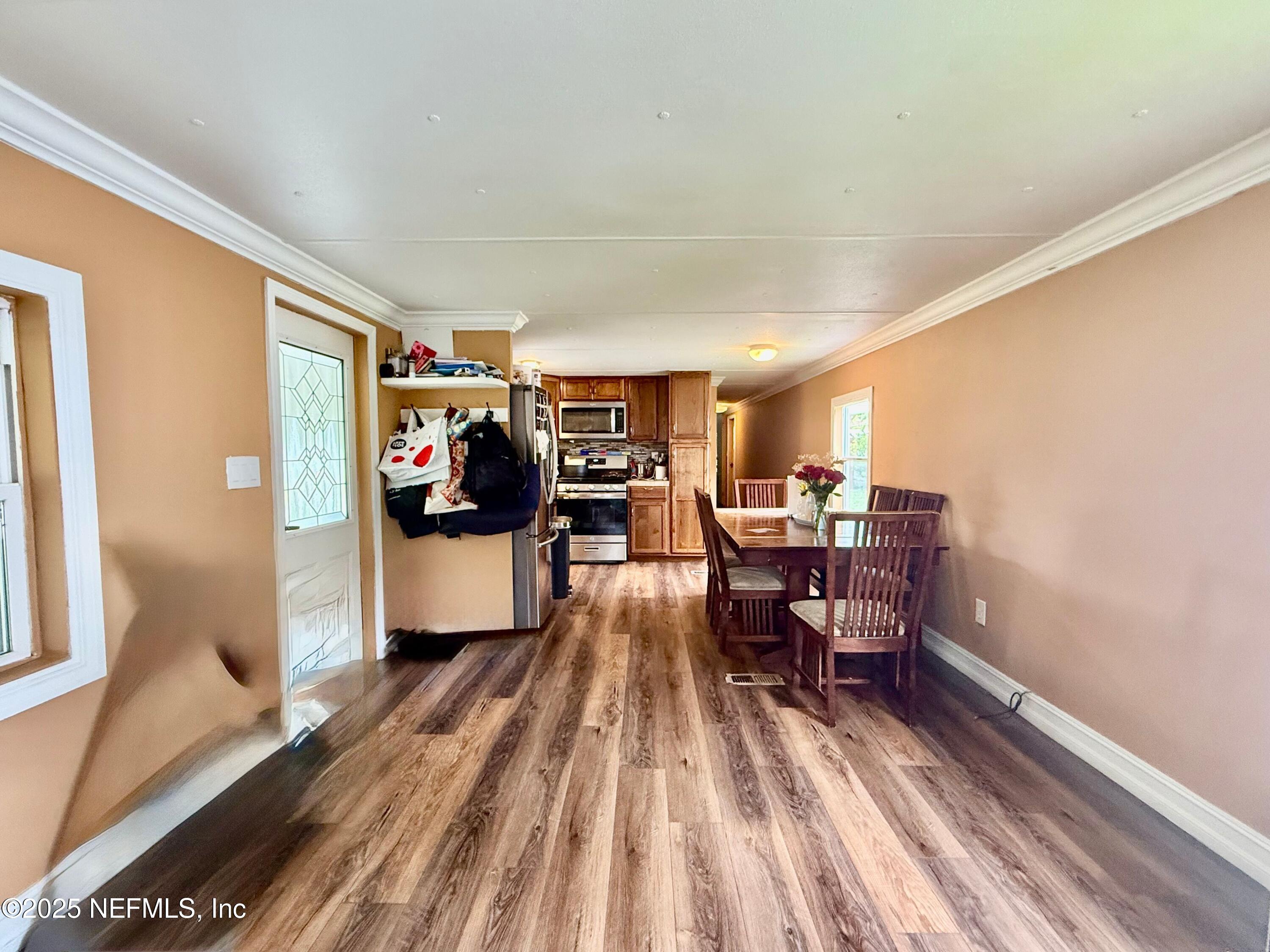 239 Pine Tree Trail Crescent City, FL 32112 - Photo 6 of 21 a living room with furniture and a wooden floor