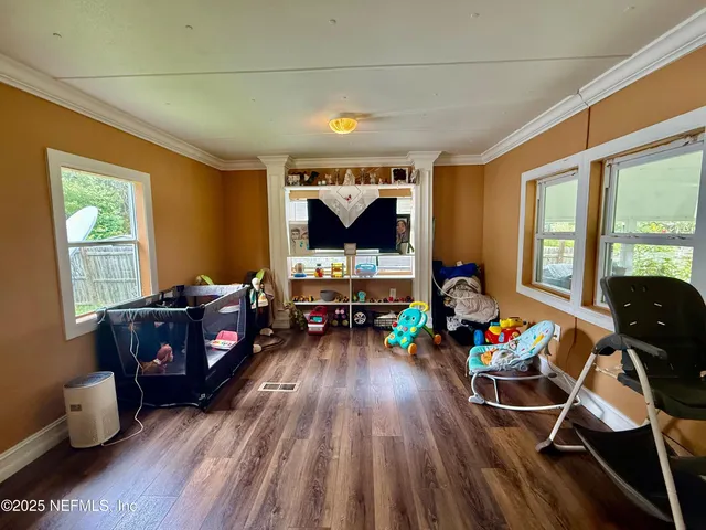 a living room with furniture and wooden floor
