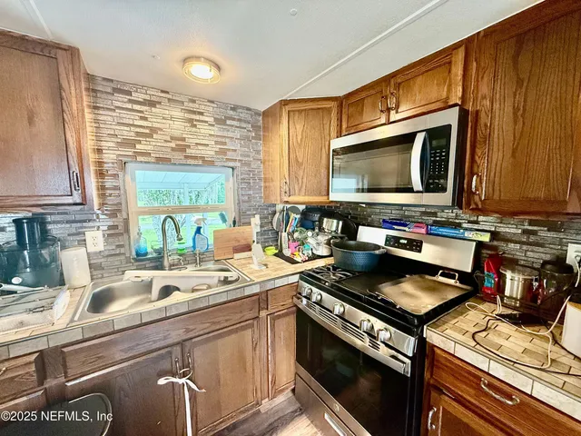a kitchen with a stove and a sink