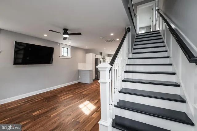 a view of entryway and hall with wooden floor
