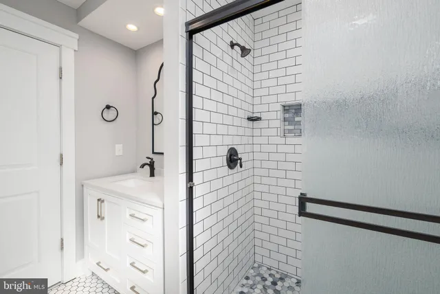 a bathroom with a shower and a sink