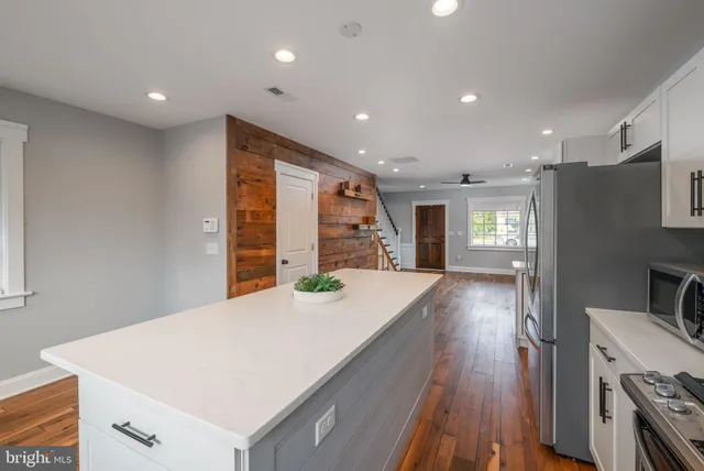 a view of kitchen with cabinets and wooden floor