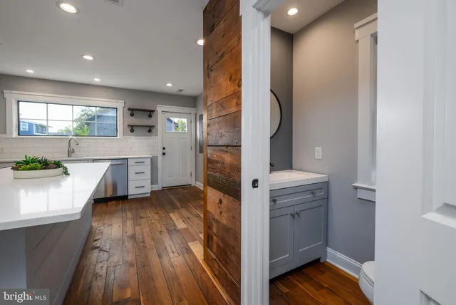 a kitchen with a refrigerator sink and cabinets