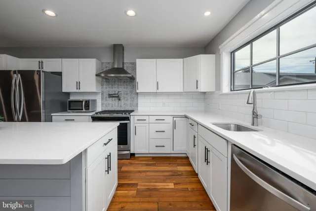 a kitchen with a sink and refrigerator