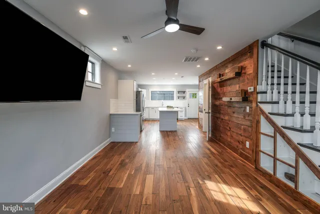 a view of a kitchen with wooden floor and a kitchen