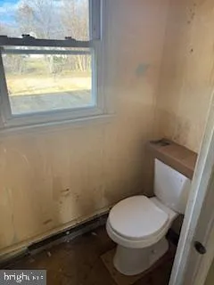 a white toilet sitting next to a window