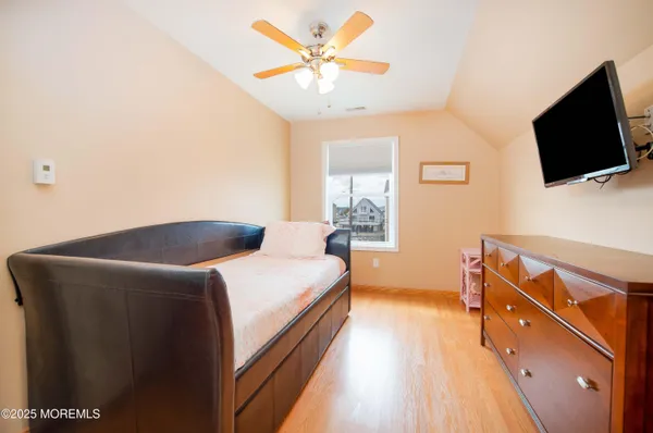 a bedroom with a bed and flat screen tv