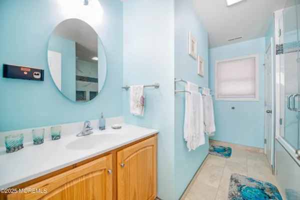 a bathroom with a bathtub a shower and a sink