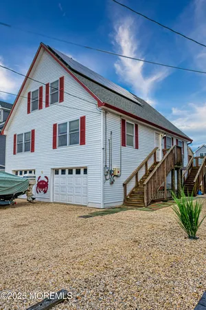 a view of a house with wooden fence