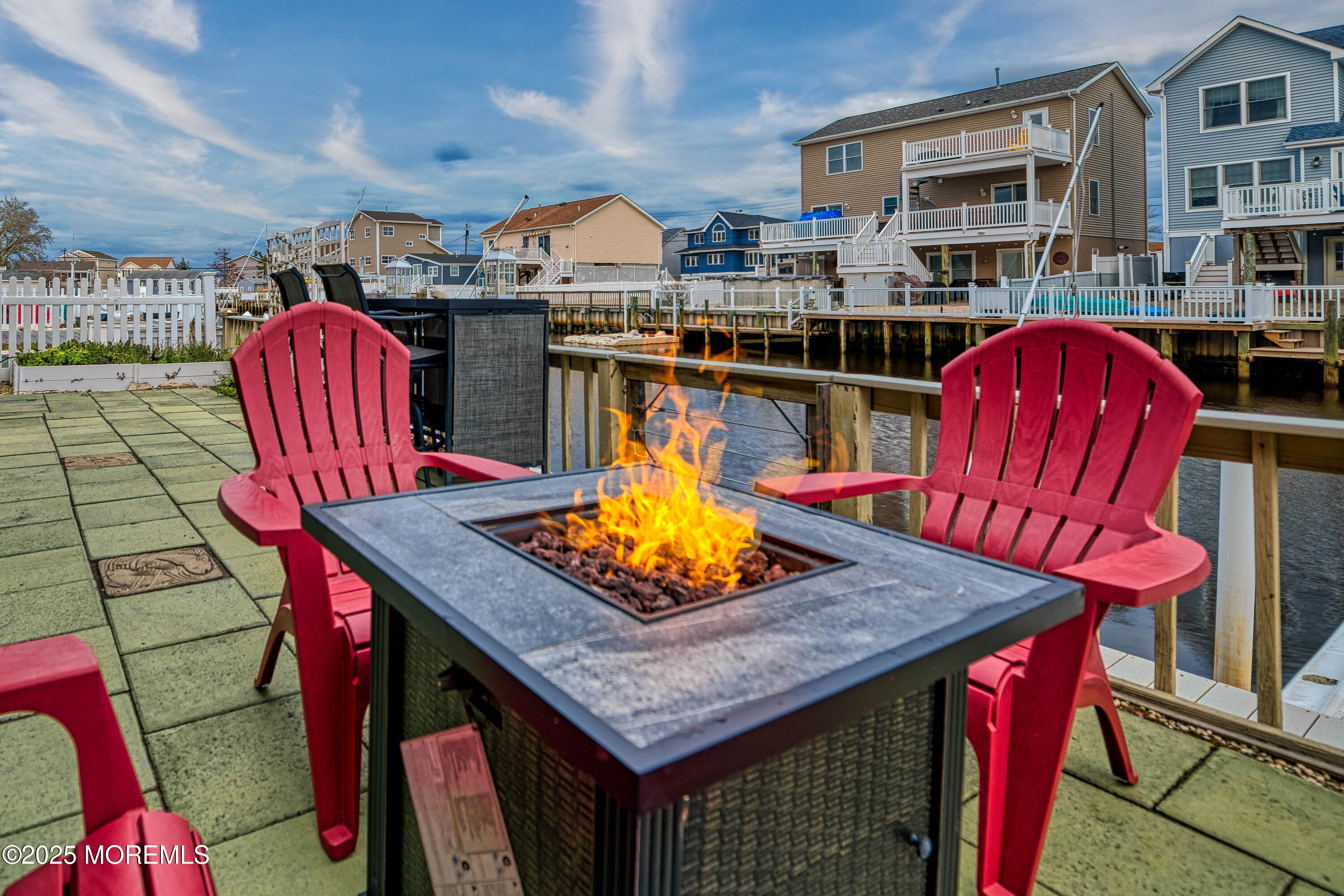 45 Sylvia Lane Manahawkin, NJ 08050 - Photo 34 of 36 a outdoor dining space with furniture and red umbrella
