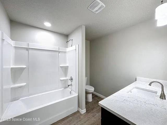 a bathroom with a sink vanity and mirror