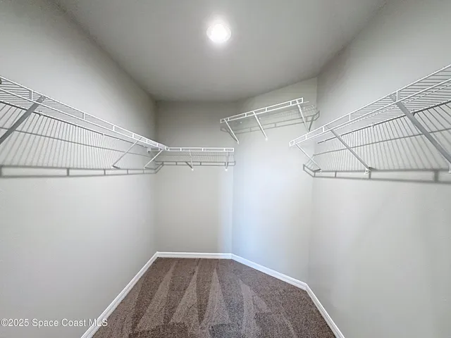 a bathroom with a granite countertop sink a toilet and a large mirror