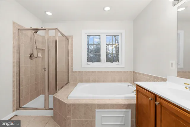 a bathroom with a sink a mirror and a shower