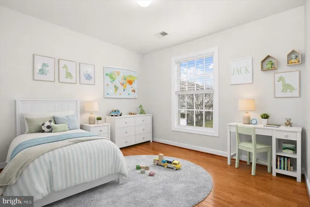 a bedroom with a bed and a table in it