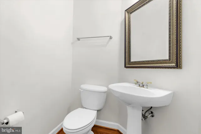 a bathroom with a sink toilet and mirror