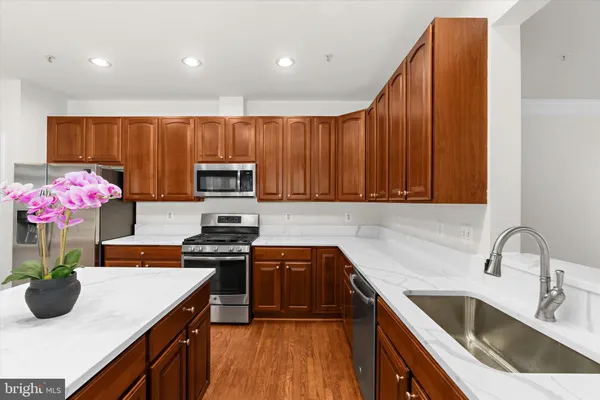 a kitchen with a sink microwave and cabinets