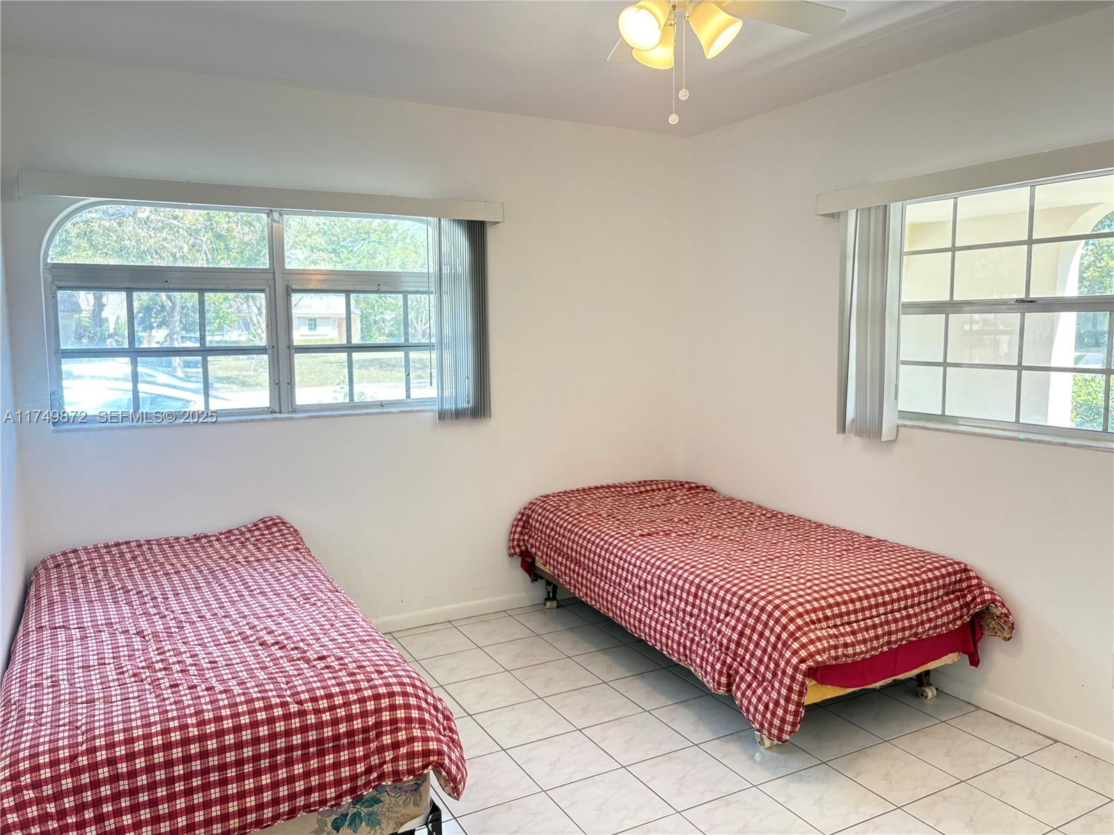 11260 Southwest 172nd Street, Unit II2831 Miami, FL 33157 - Photo 14 of 24 a bedroom with a bed and a window