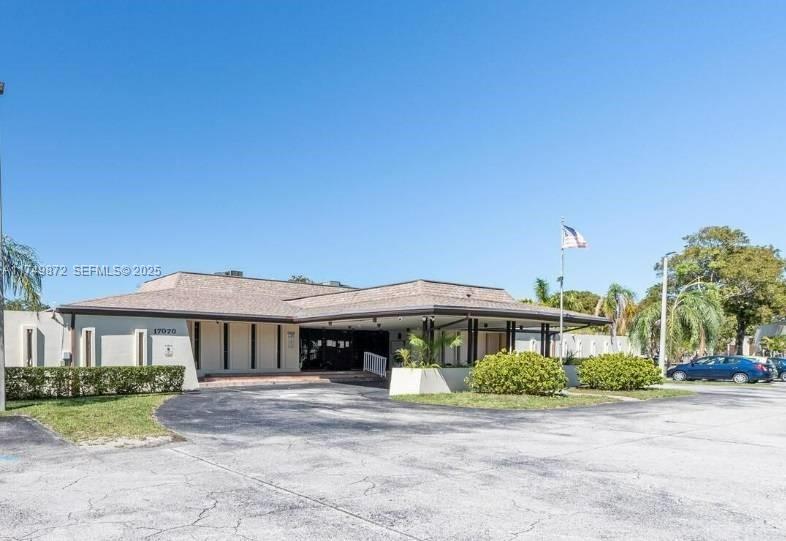 11260 Southwest 172nd Street, Unit II2831 Miami, FL 33157 - Photo 20 of 24 a front view of a house with a yard and garage
