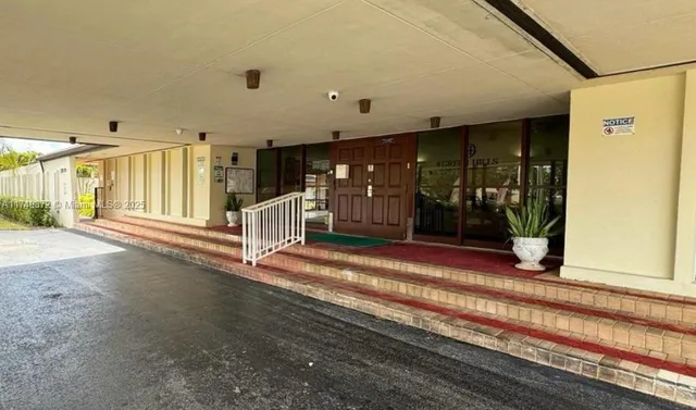 a view of a swimming pool with a yard and a chair